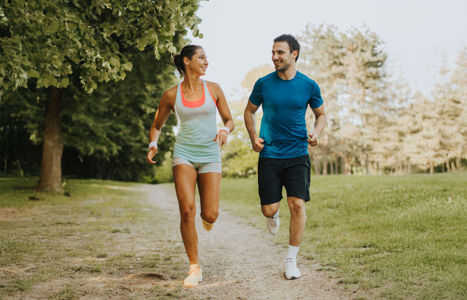 healthy woman and man running in a park