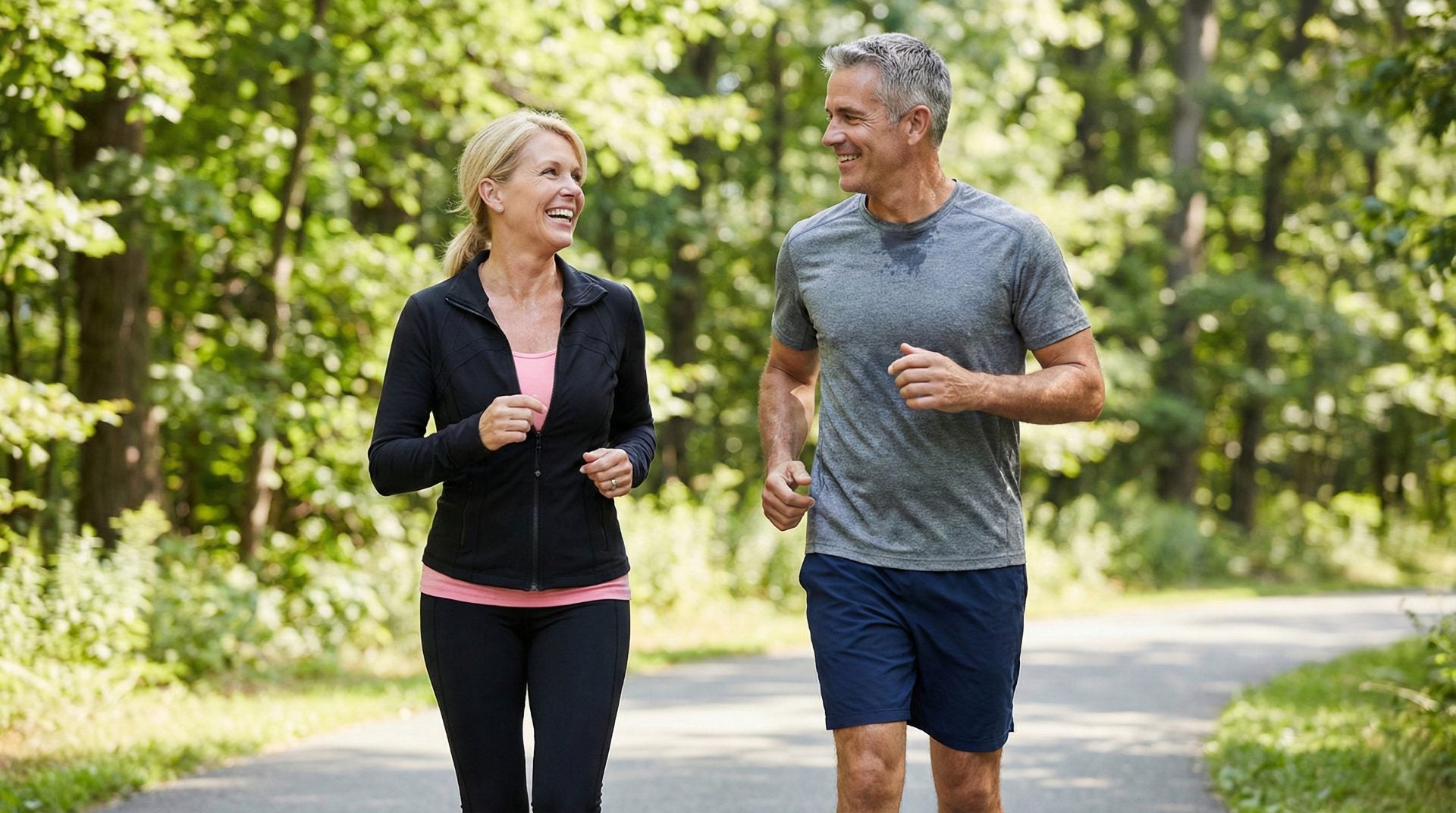 Man and woman jogging together on a path in a park